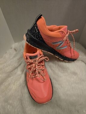 New Balance Women's Coral Orange Trail Sneakers with Black Speckled Midsole
